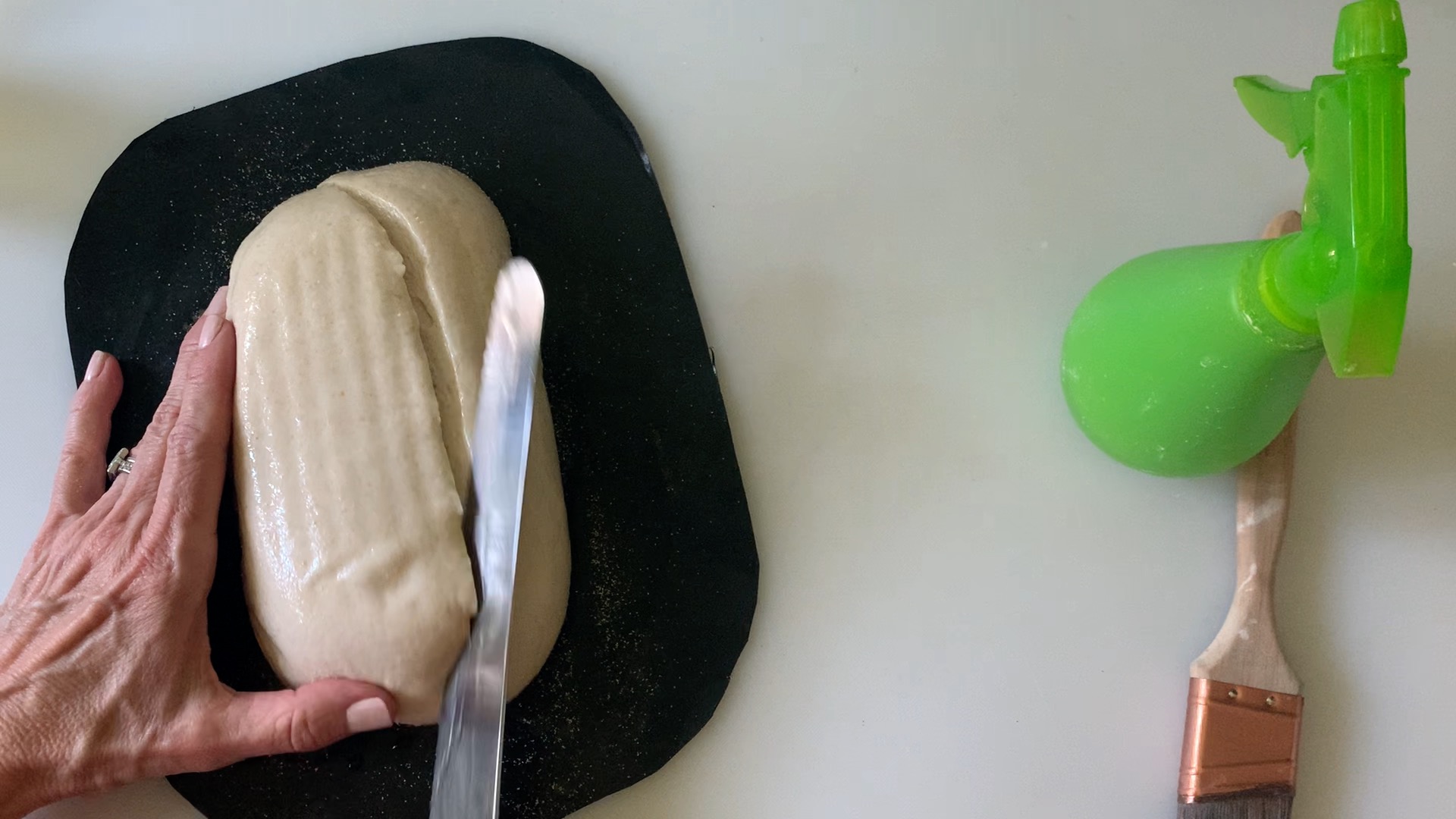 Scoring the loaf with a serrated knife