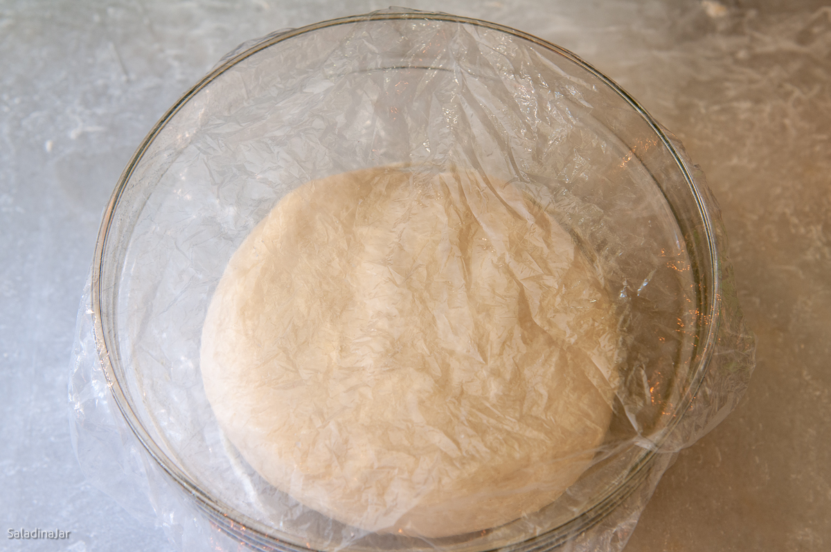 dough covered with a shower cap