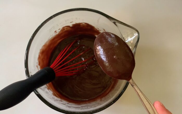 testing pudding thickness with a spoon