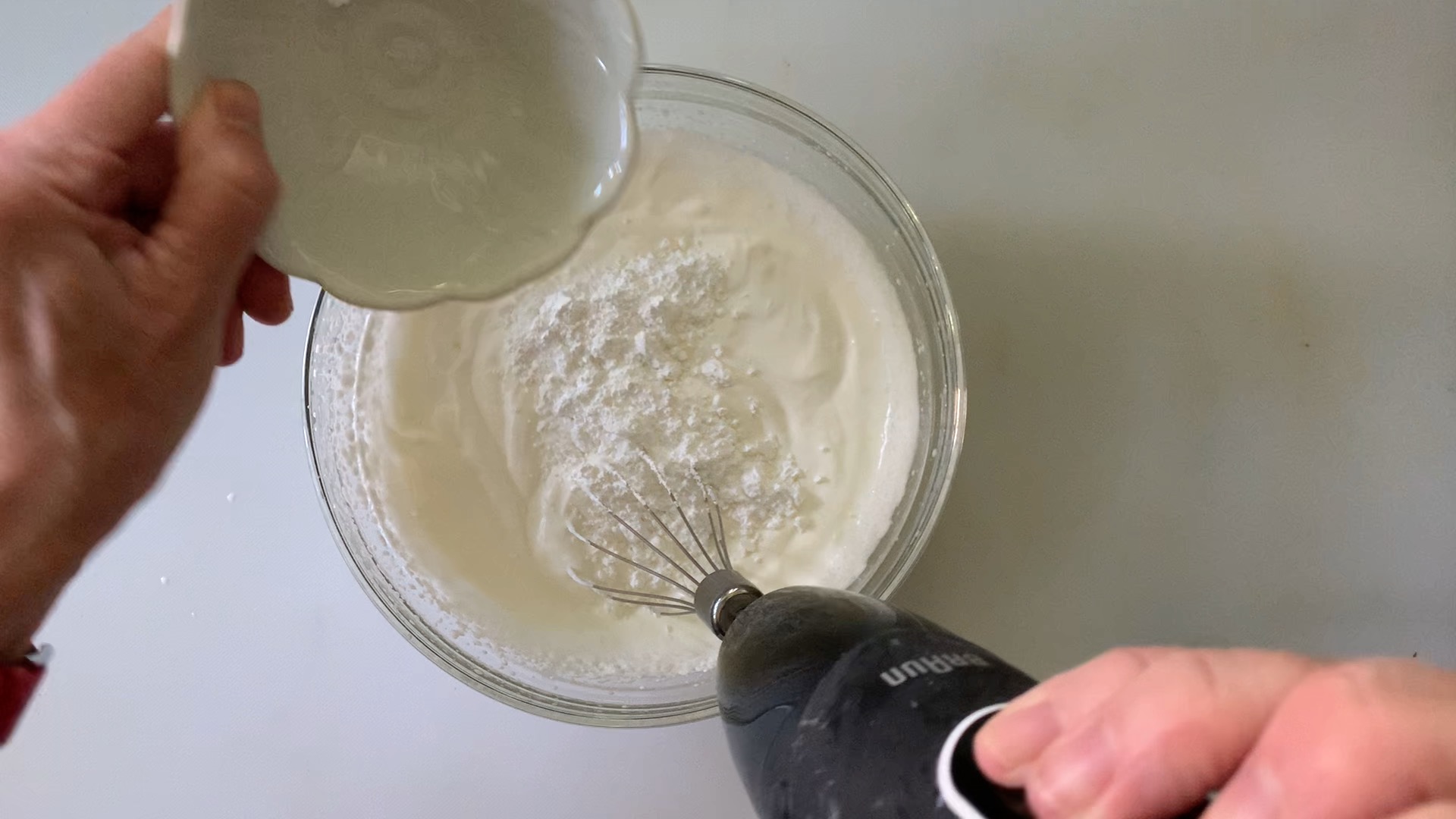 Adding powdered sugar and vanilla extract to whipped topping