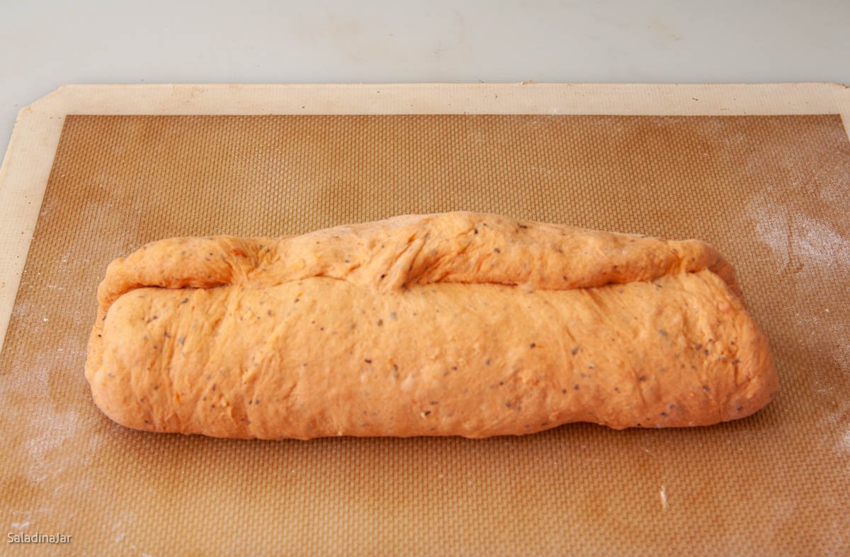 rolling dough into a cylinder.