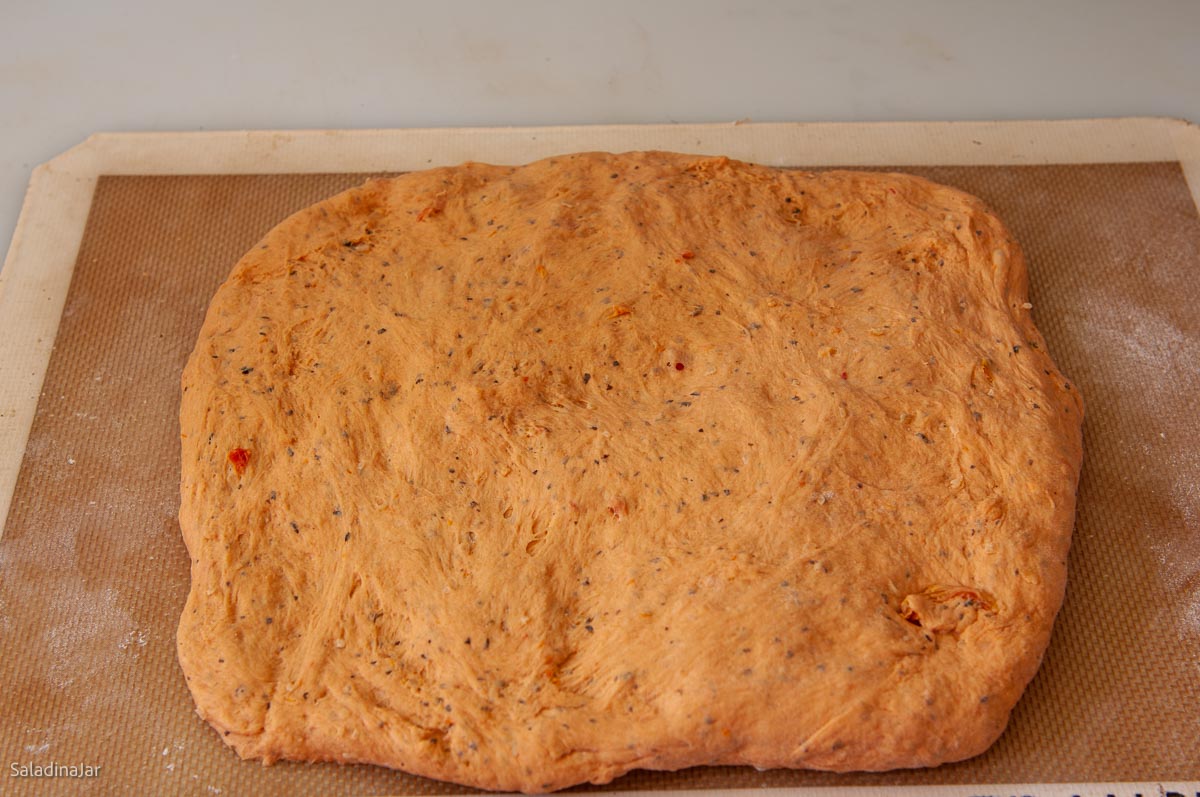 shaping dough into a rectangle.