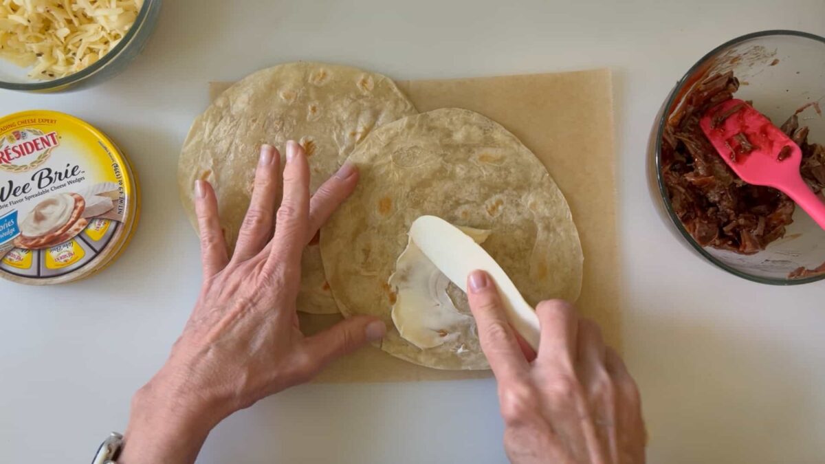 smearing the flour tortillas with Brie
