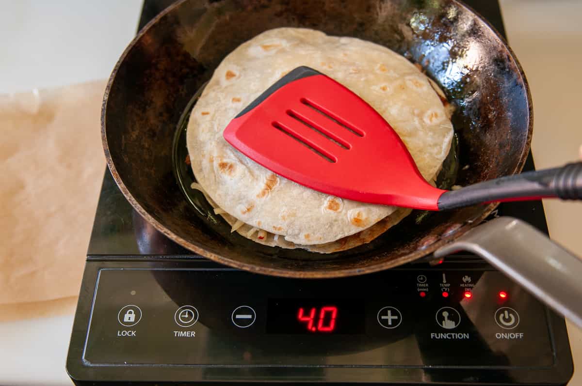 Occasionally press the tortilla with a flat spatula to help the cheese melt.