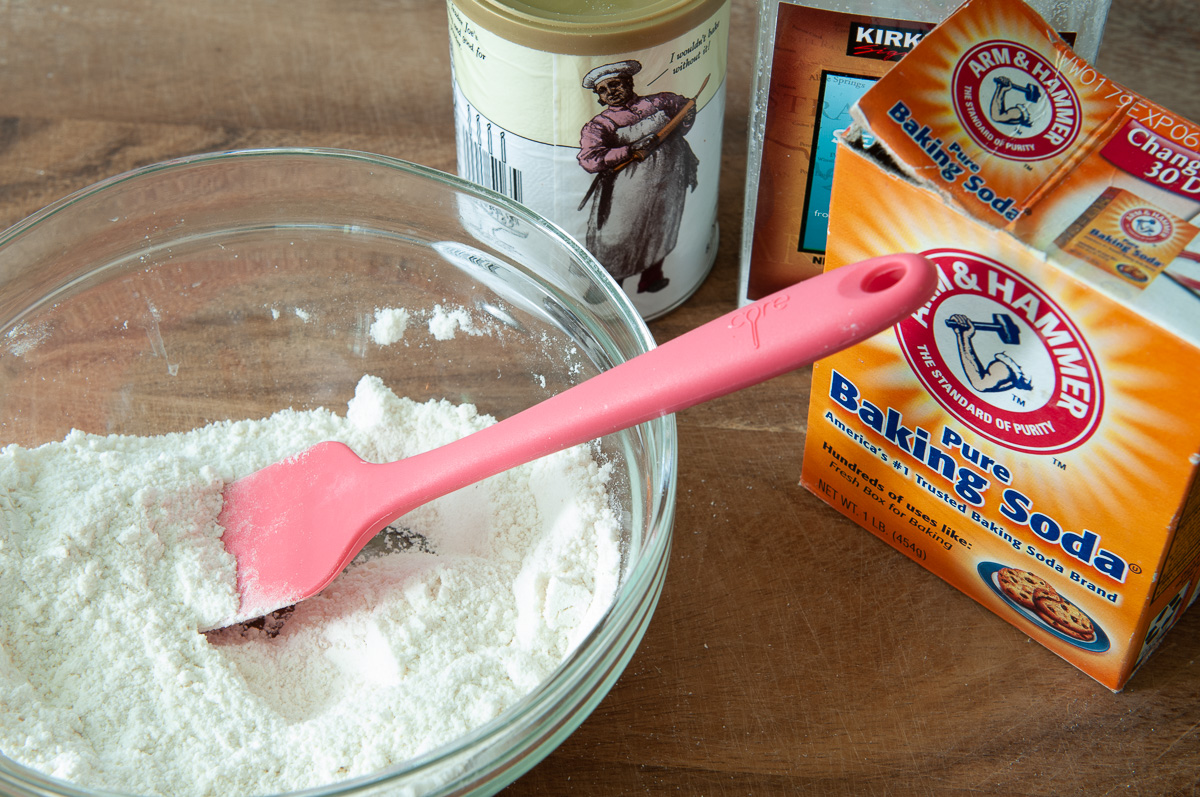 assembling the cornmeal layer and showing the dry ingredients in a bowl.