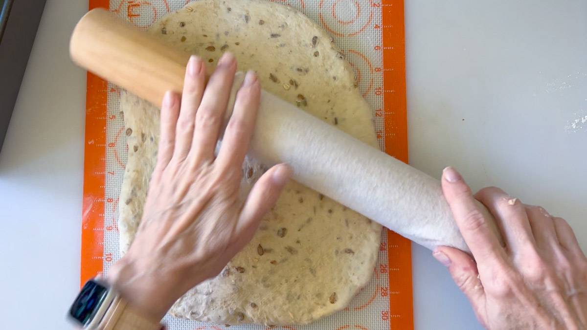 flattening dough with a rolling pin