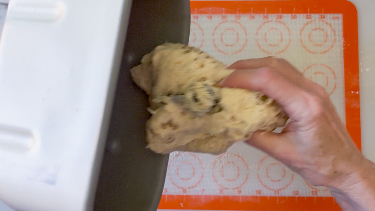 removing the dough from the pan to a floured surface