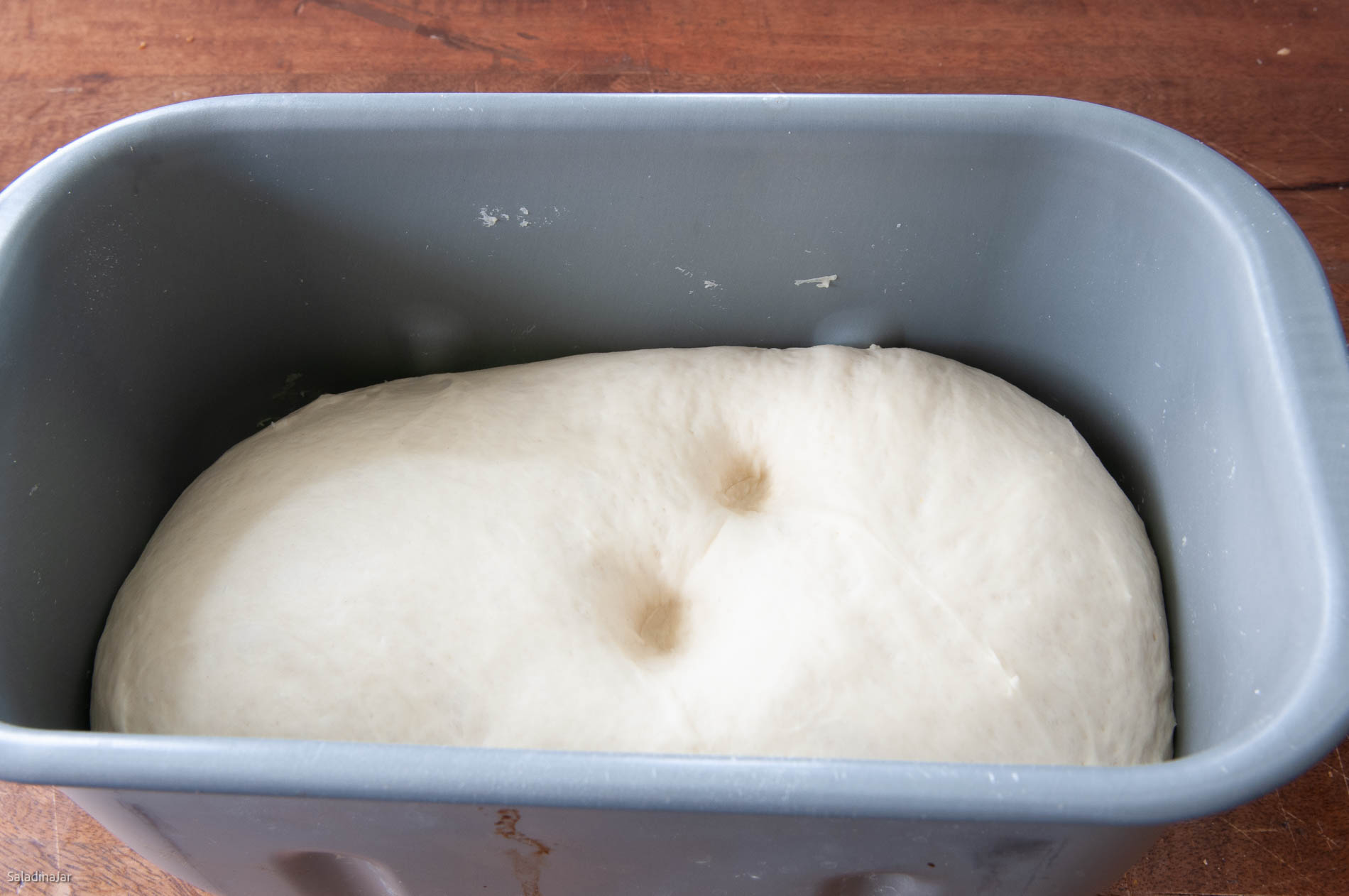testing dough to see if it's ready to shape.