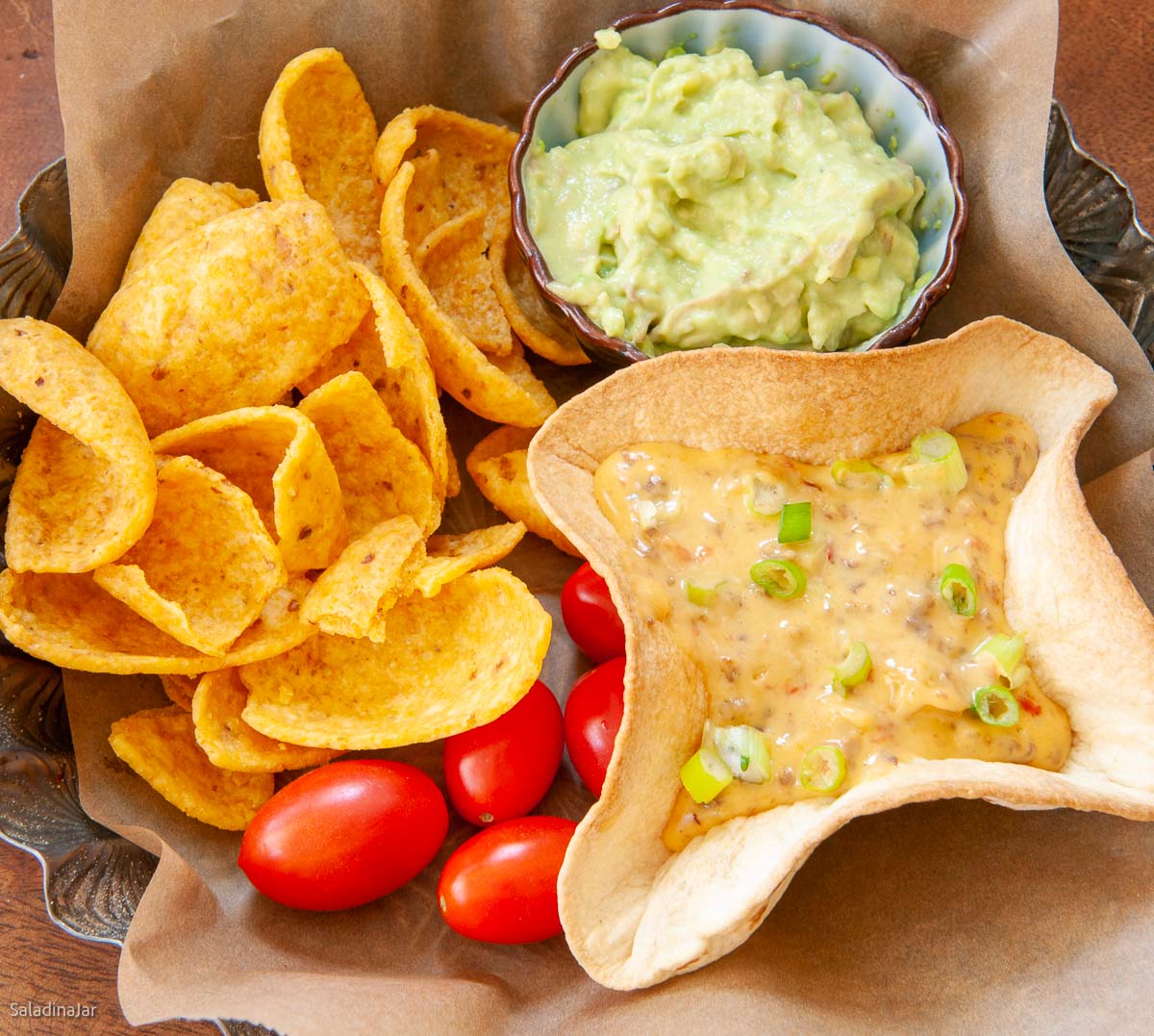 Dip served in baked tortillas bowls