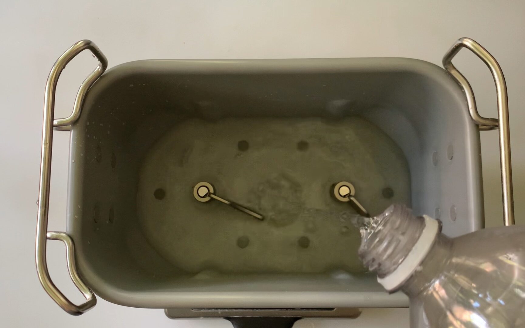 adding water to bread machine pan