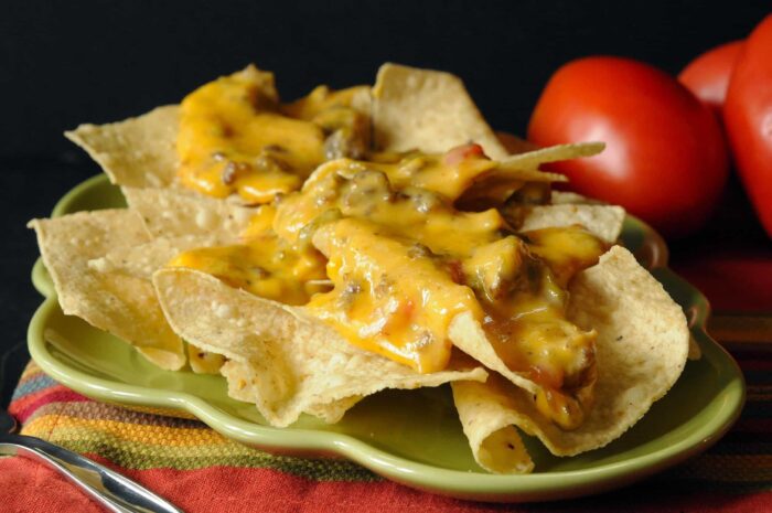 cheese dip on plate with tomatoes in background