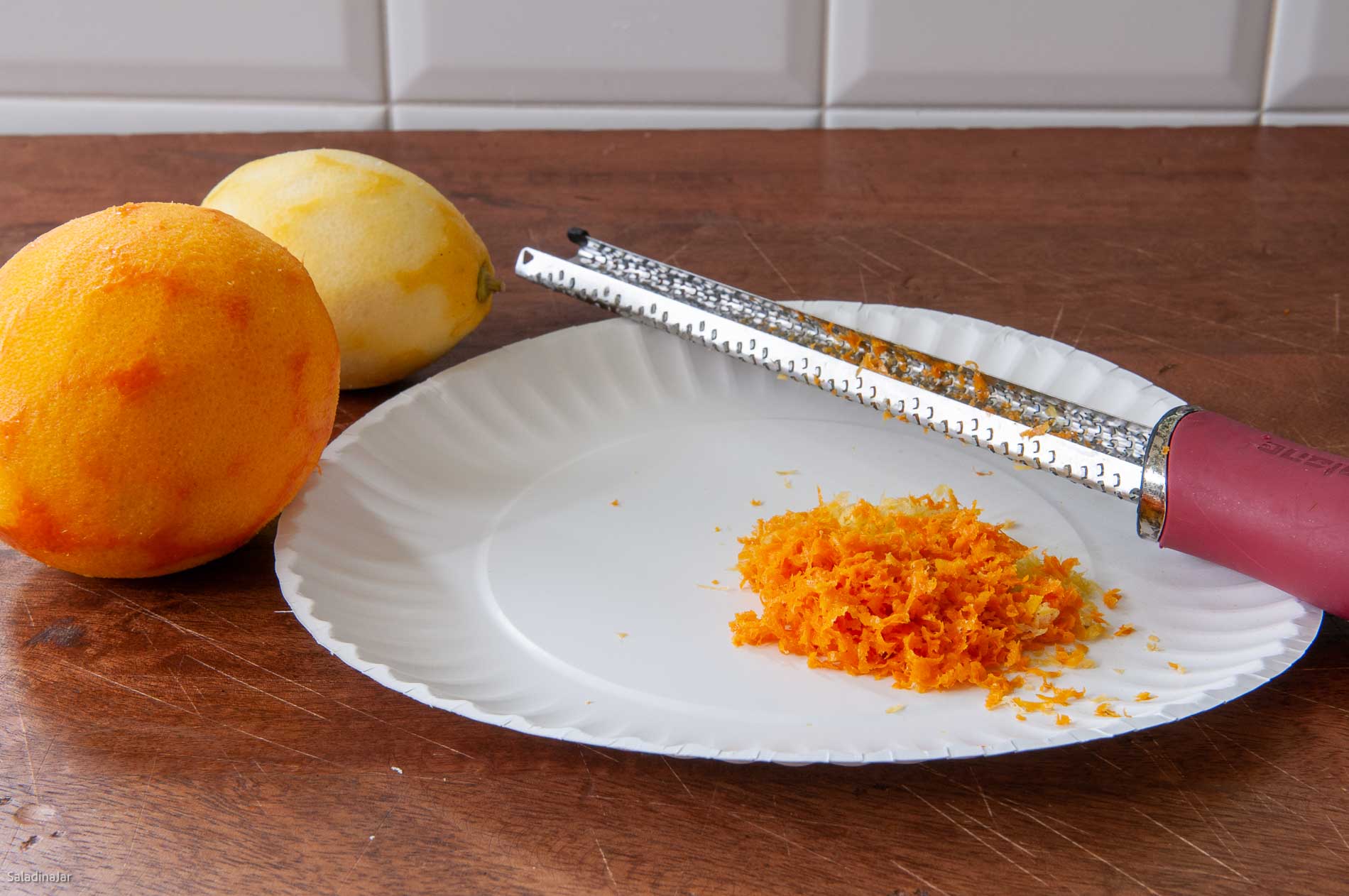 Grating rind for orange curd with a microplane grater.