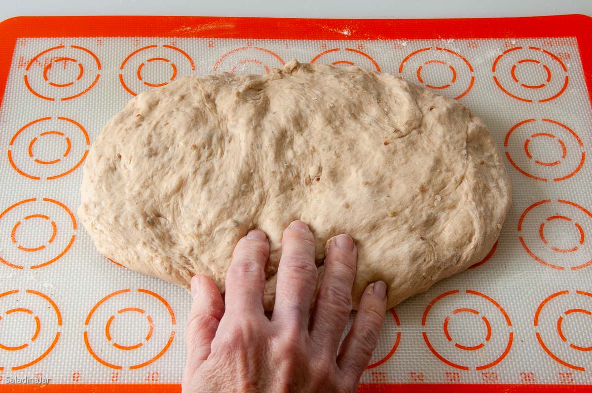 shaping the dough into a rectangle with your fingers.