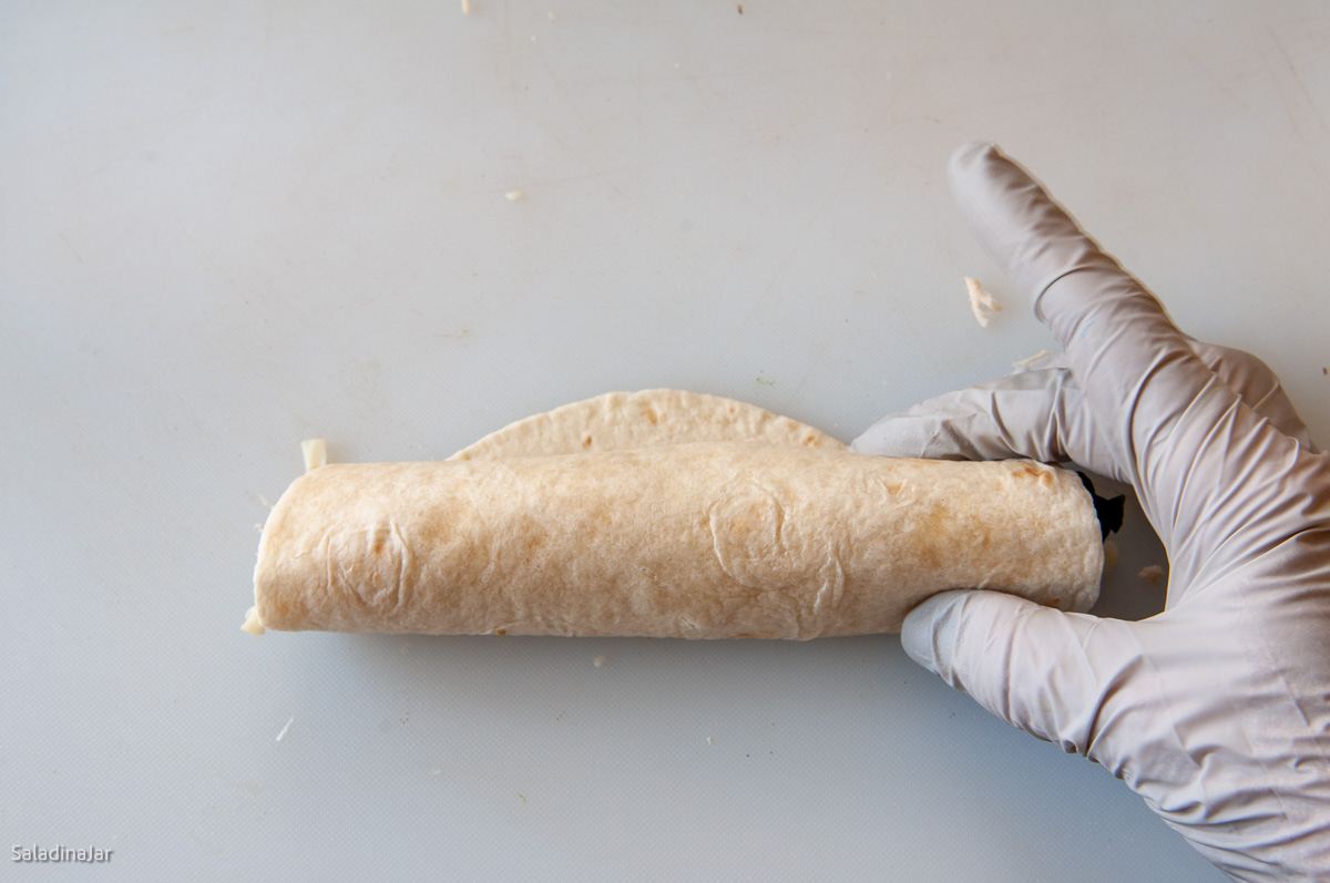 rolling the tortilla.