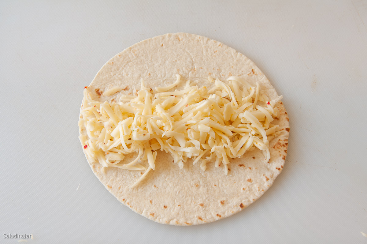 cheese placed down the middle of a tortilla