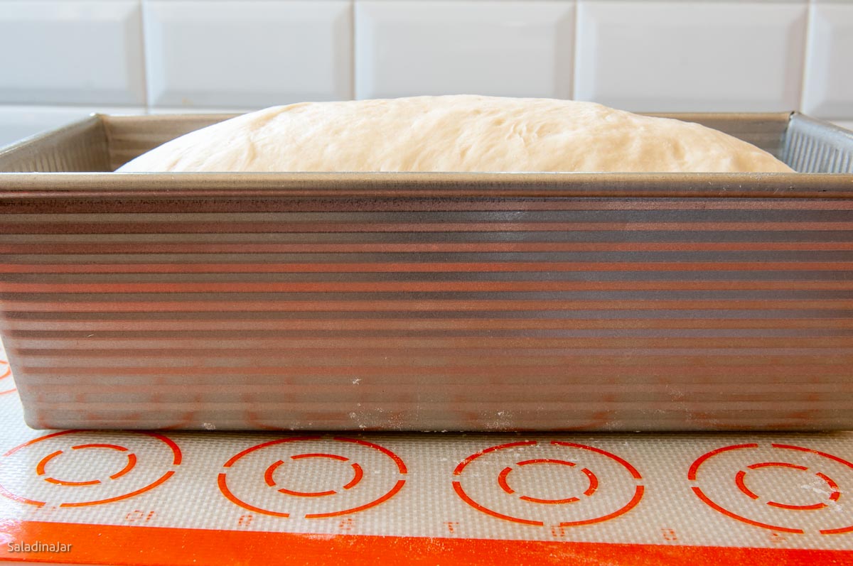 dough peeking over the side and ready to bake.