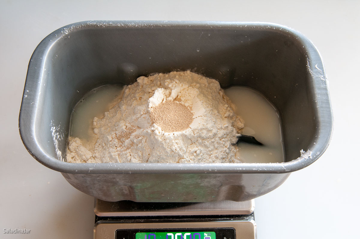 adding all ingredients to bread machine pan