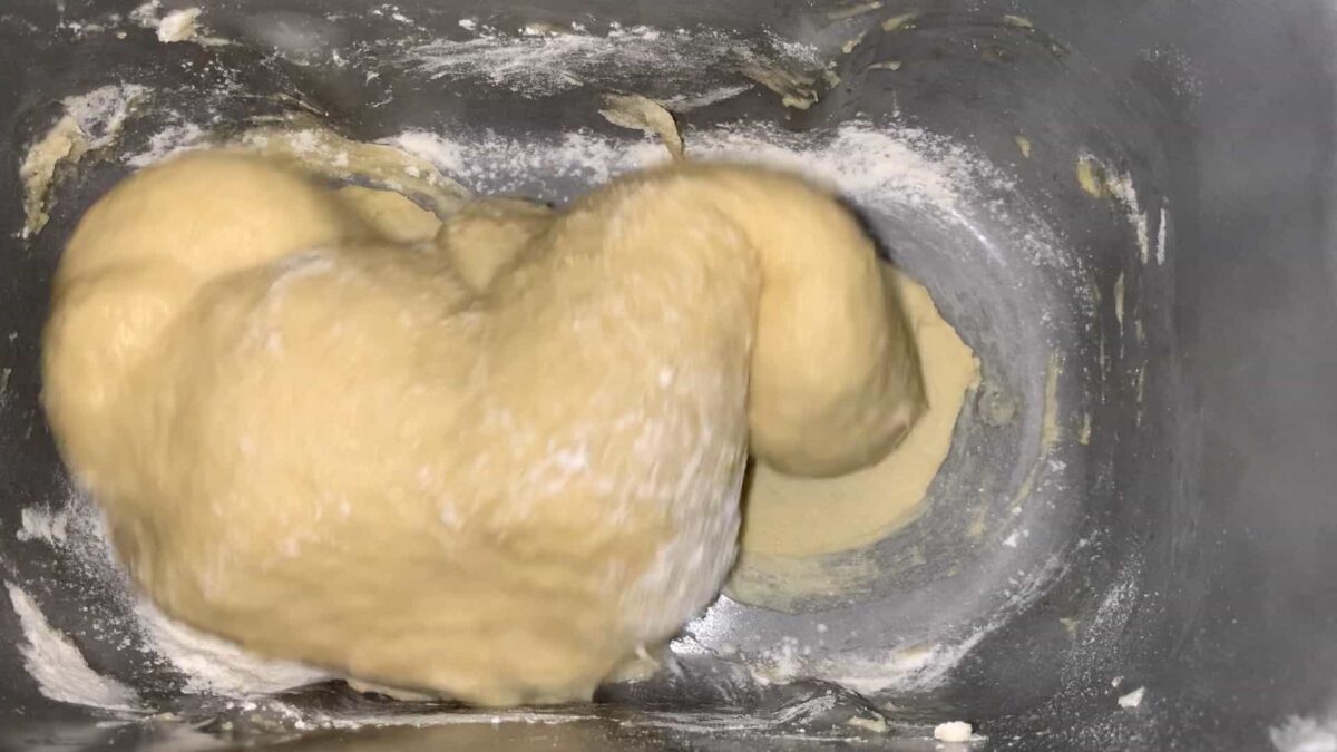 dough should stick to the side and pull away cleanly as it nears the end of the kneading phase