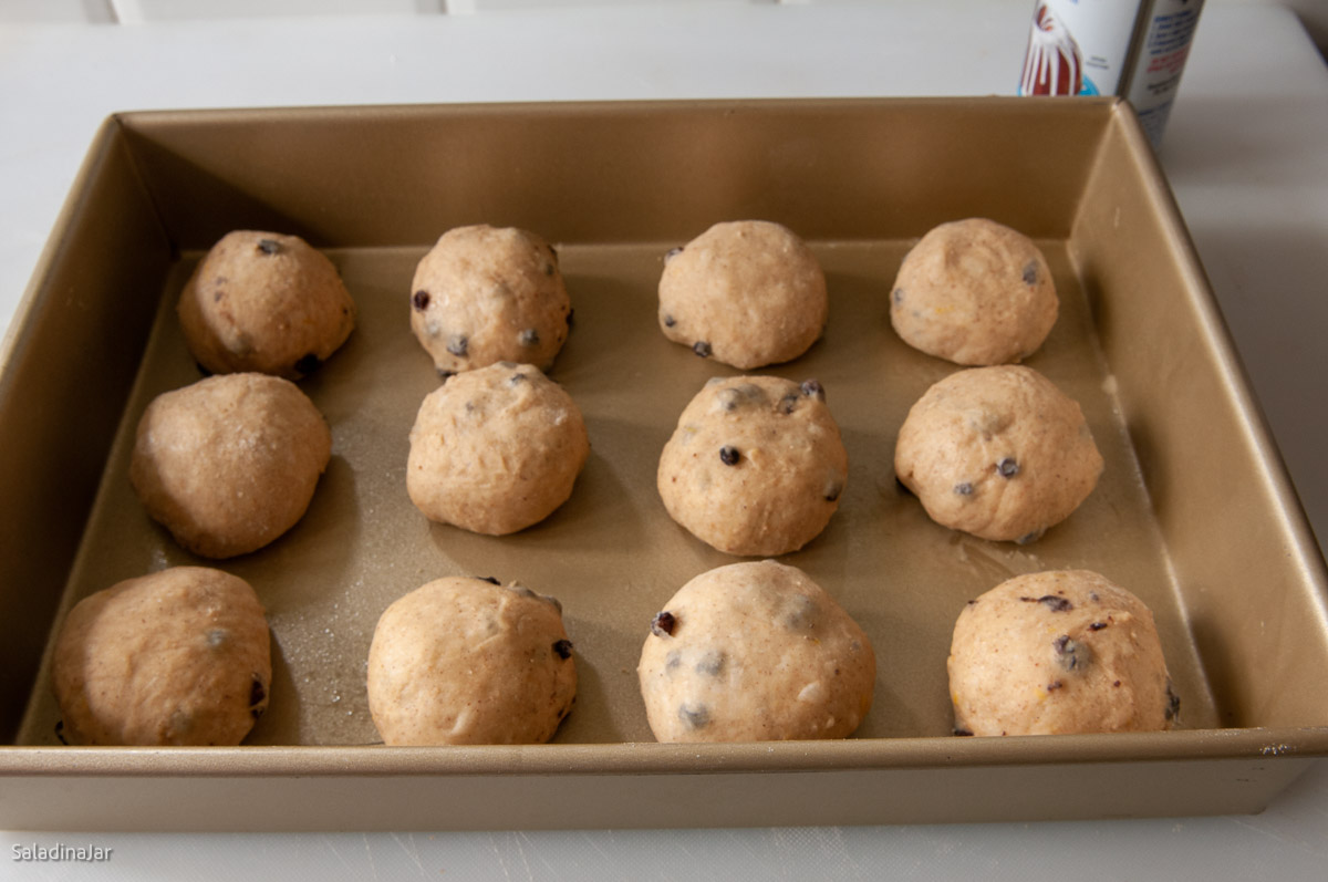 shaped rolls sitting in a pan before the final rise.