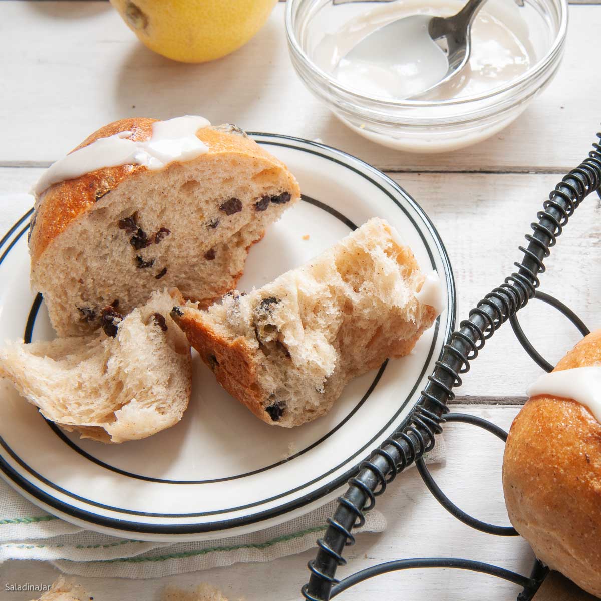 split hot cross bun so you can see the  light and fluffy texture inside.