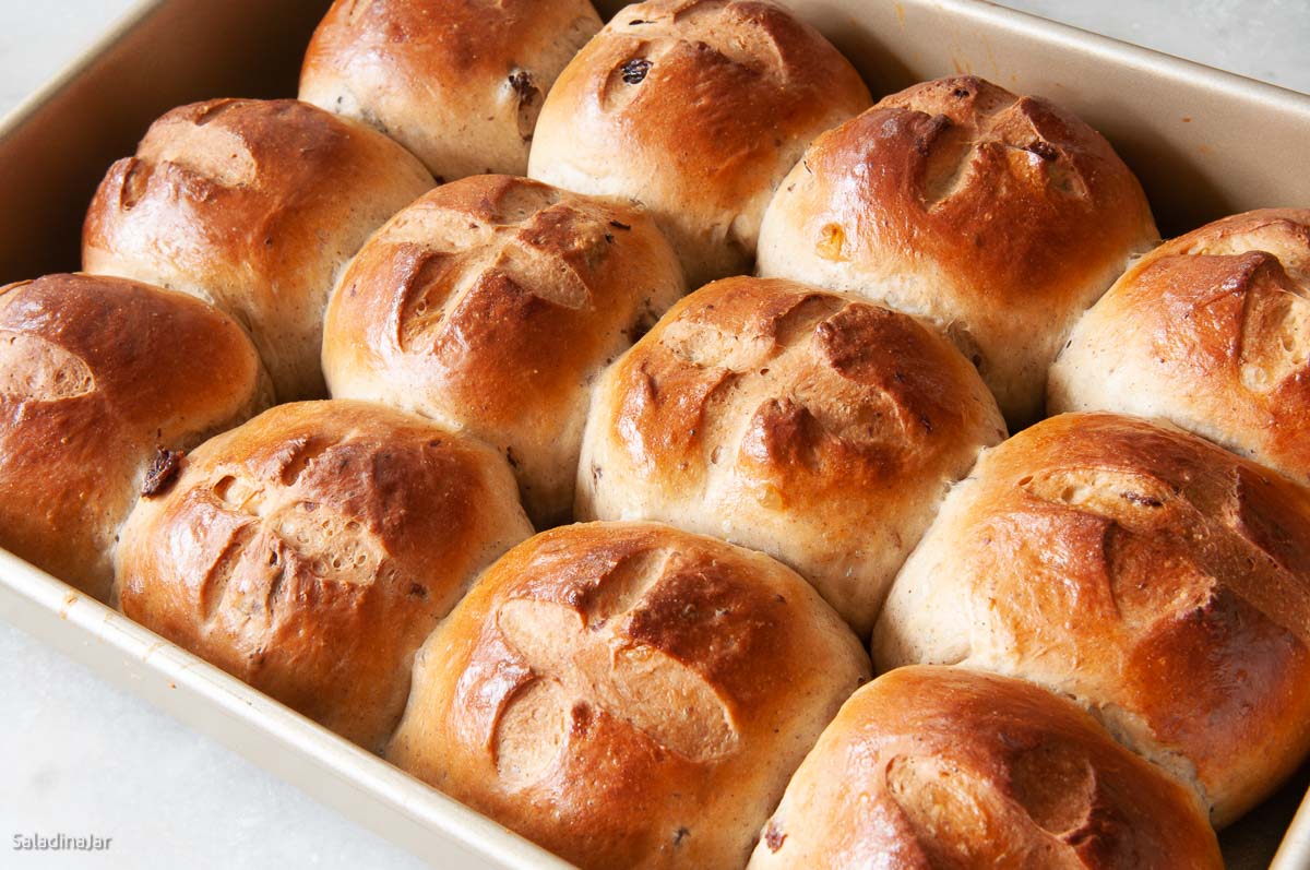 baked hot cross buns still in the pan without frosting.