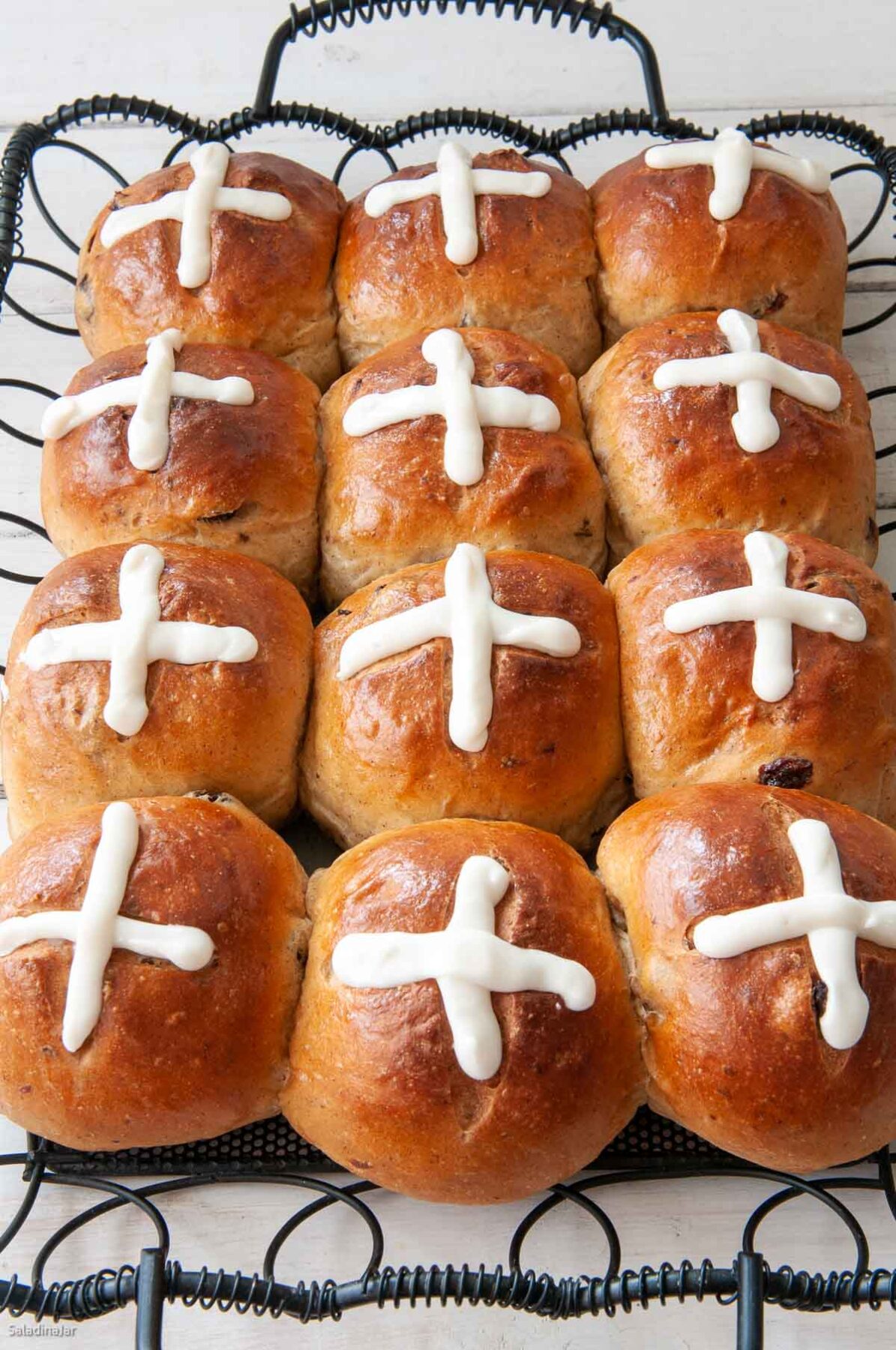 baked hot cross buns on a serving tray.