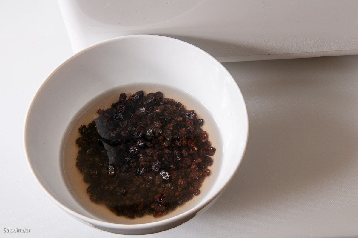 bowl of raisins soaking in water.