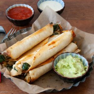 chicken and spinache flautas with guacamole and salsa on the side