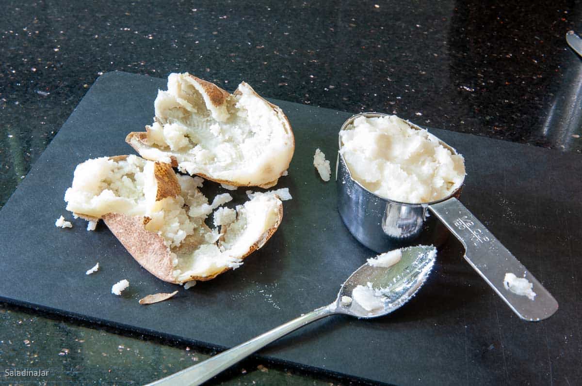 preparing a fresh potato to add to the bread machine