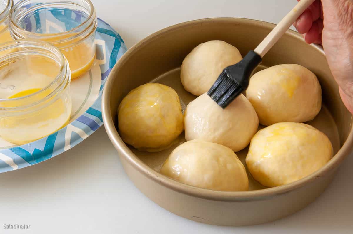 glazing dinner rolls with a small silicone brush
