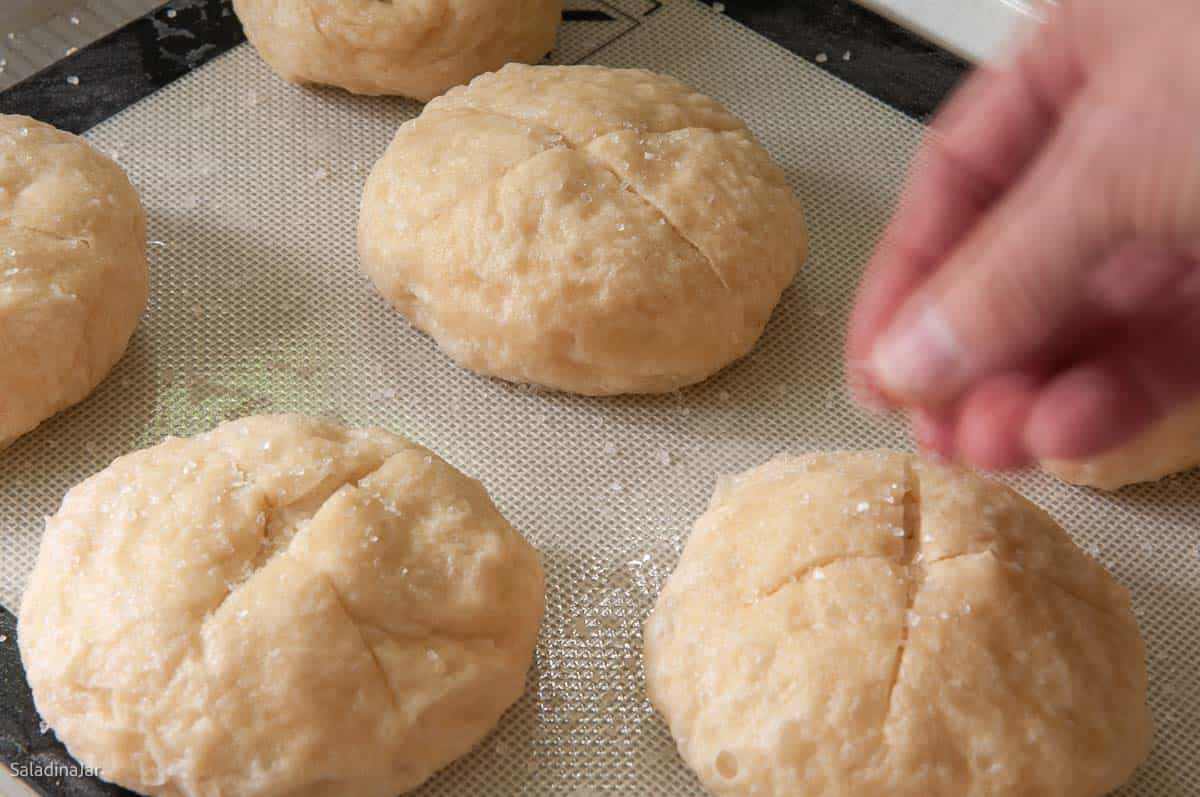 Sprinkle boiled but unbaked rolls with coarse salt.