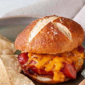 Sausage and cheese sandwich made with pretzel buns.