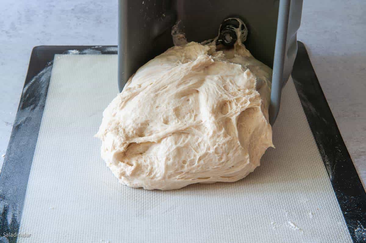 Transferring dough from the pan to the floured surface for shaping
