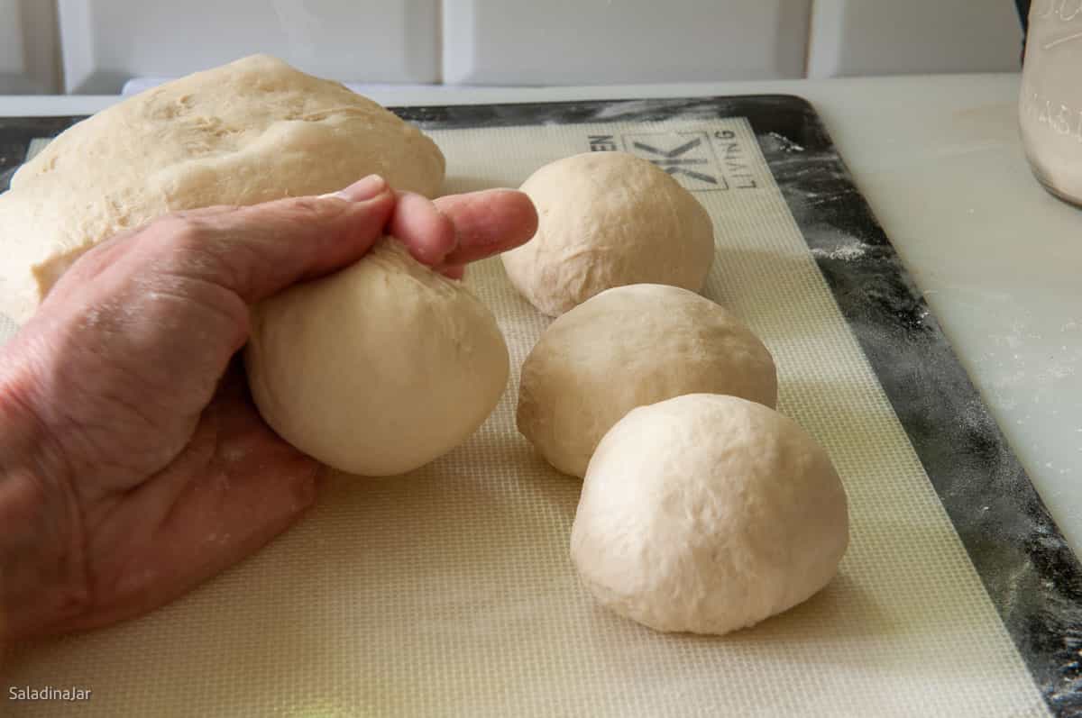 Forming balls with the dough portions.