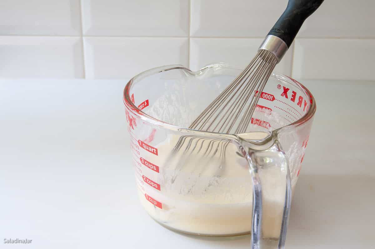 whisking cooked dressing.