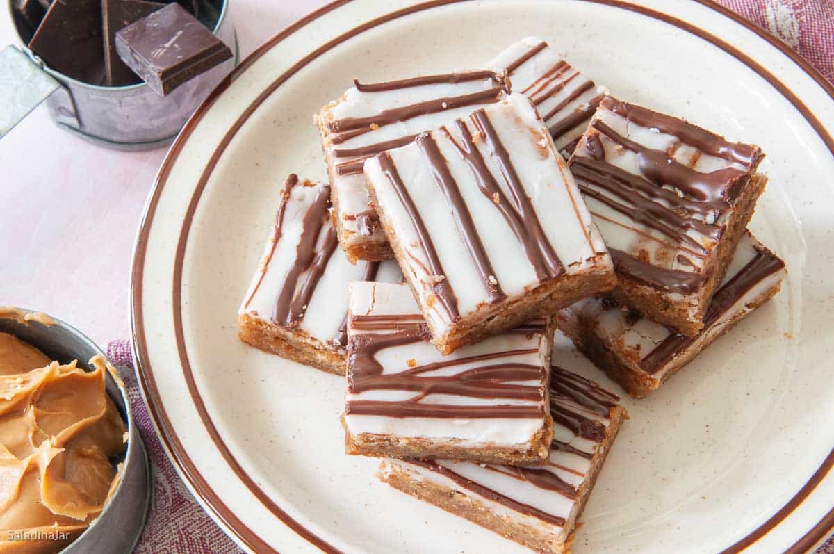 Cut Glazed Peanut Butter Cookies Bars on a plate ready to eat.