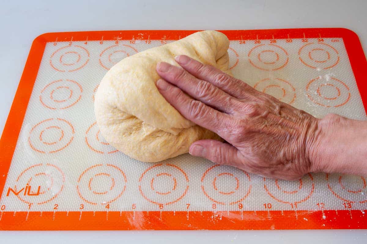 kneading and pressing the bubbles in the dough