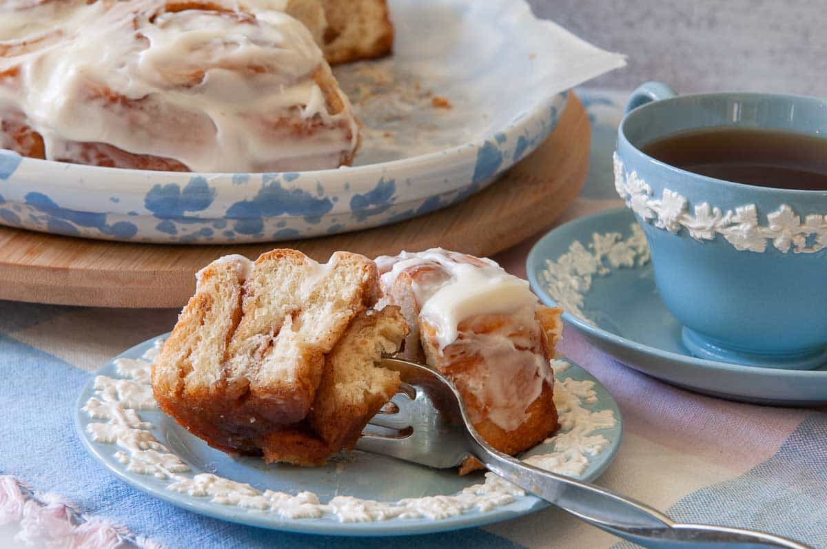 sliced cinnamon roll with a cup of coffee.