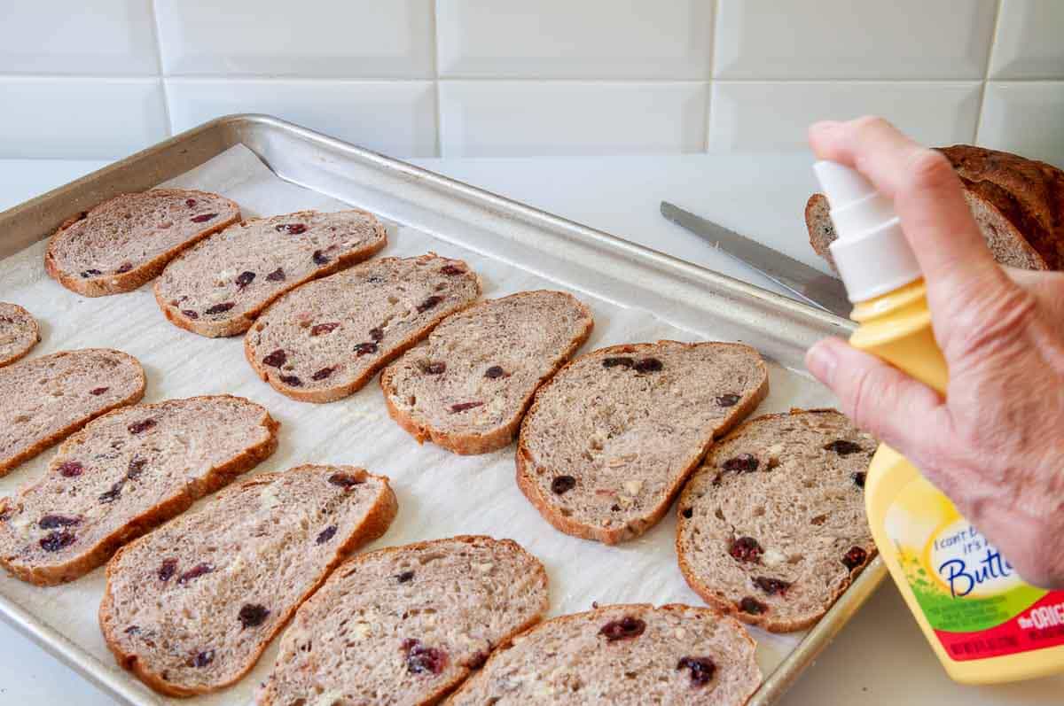 Spraying slices with spray butter.