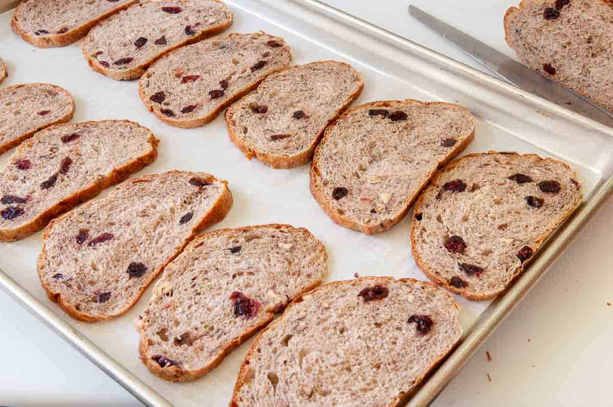 Bread slices arranged on a baking tray.