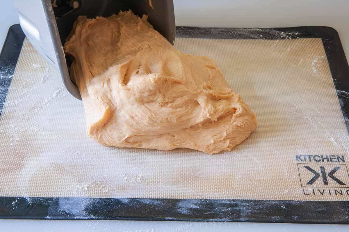 Pulling the dough onto a lightly floured surface.