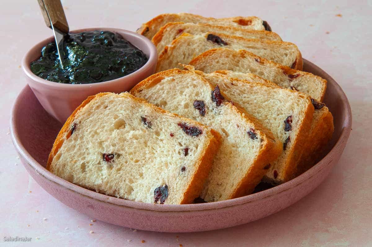 sliced egg bread with jelly in a round dish