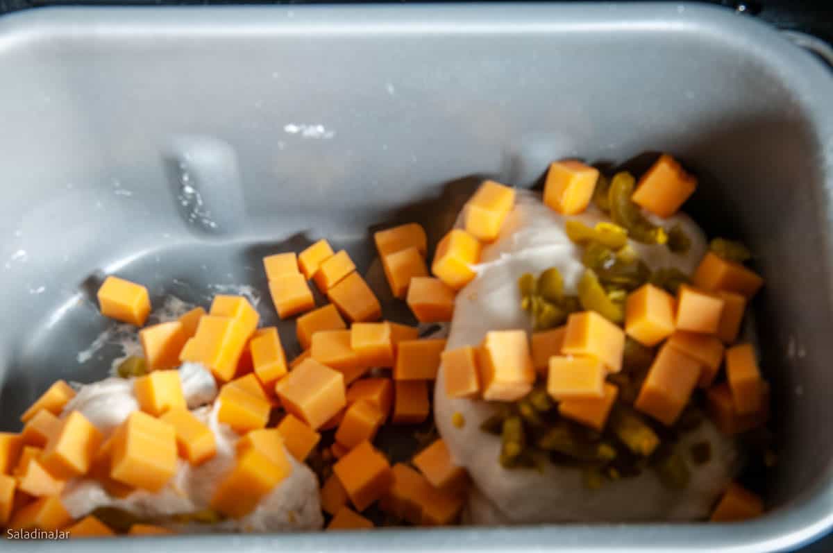 Adding the cubed Cheddar cheese and jalapenos.