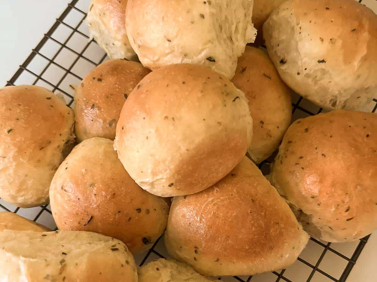 Baked rolls on a cooling rack.