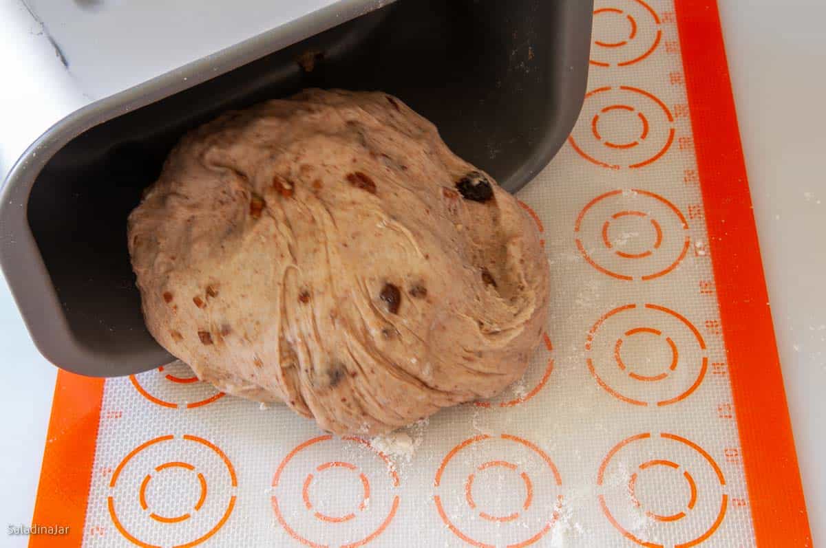 pulling the dough out of the bread machine