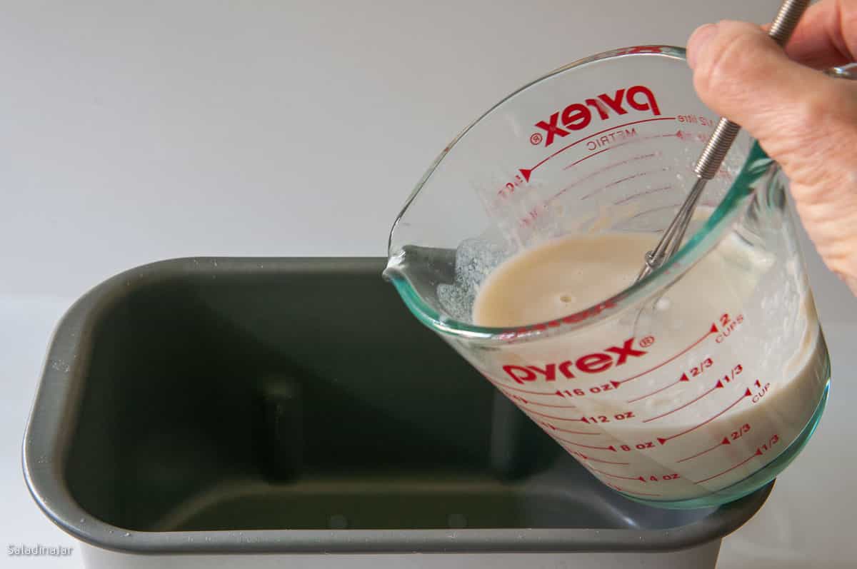 Adding the Tangzhong mixture to the bread pan.