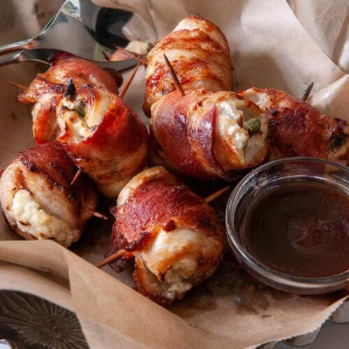 serving jalalapeno chicken bites in a basket with sauce on the side.