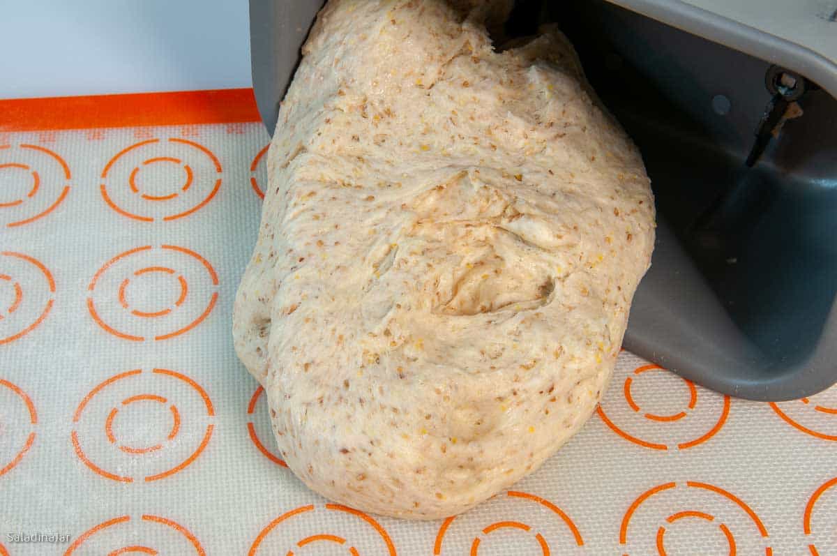 pulling the dough out of the pan onto a lightly floured surface