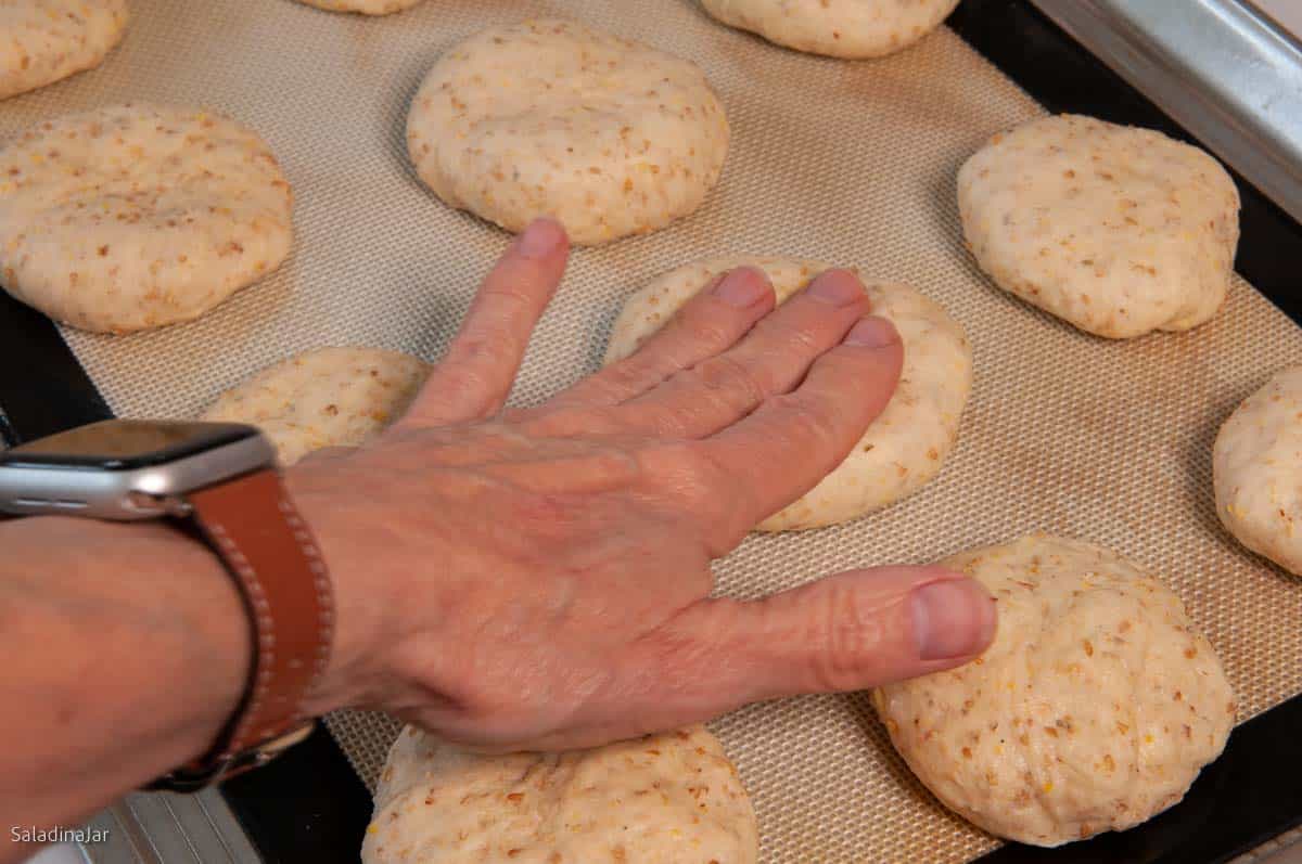 smashing the dough balls the first time.