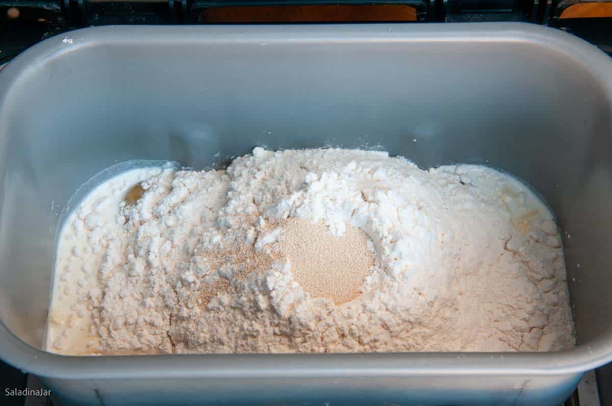 all dough ingredients have been added to the pan with the yeast last.